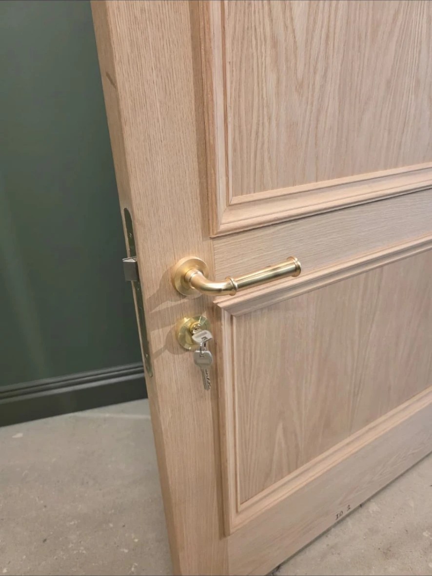 Solid oak door with brass lever handle and lock fitted