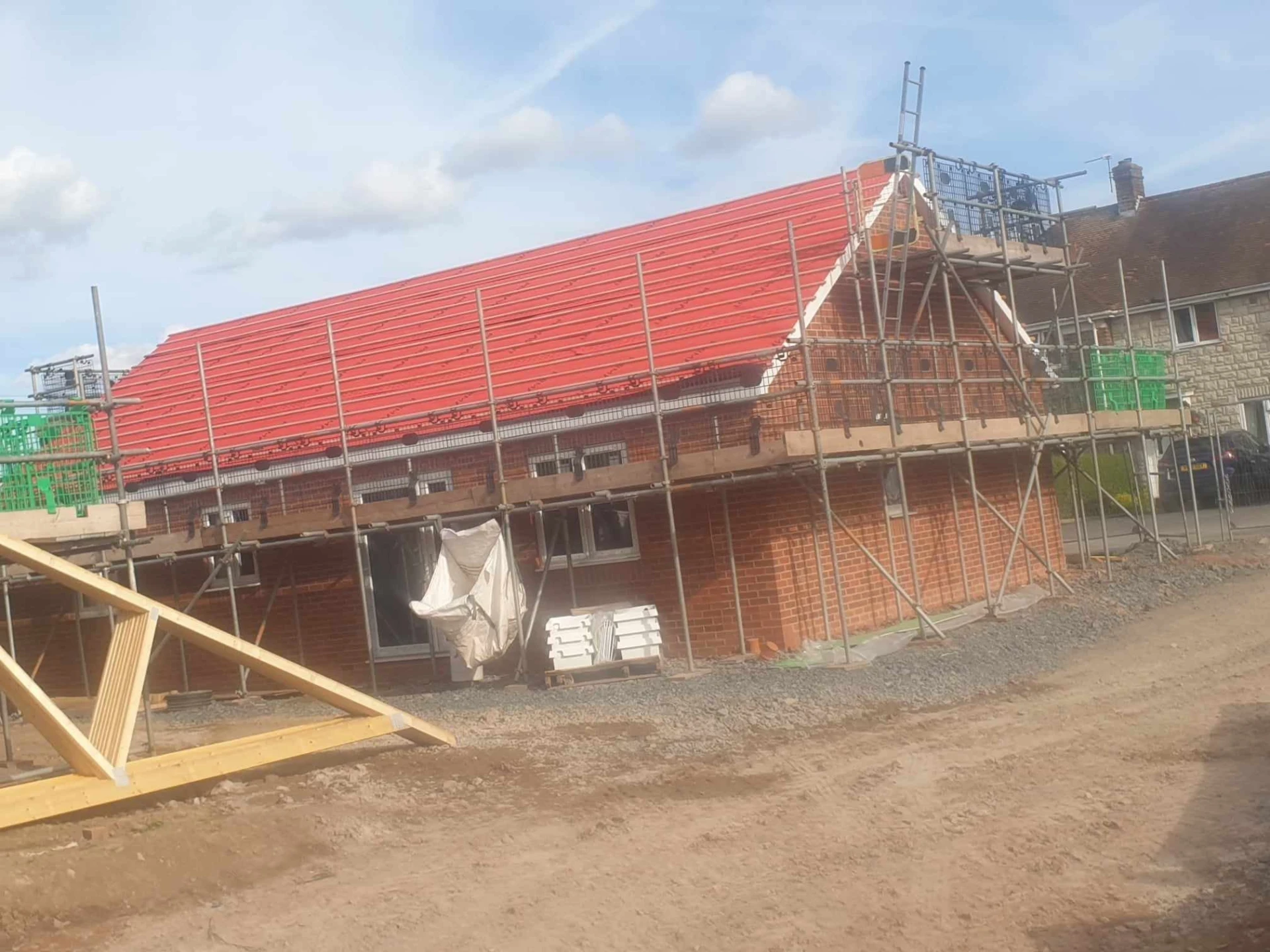 New build under construction with new roof and scaffolding